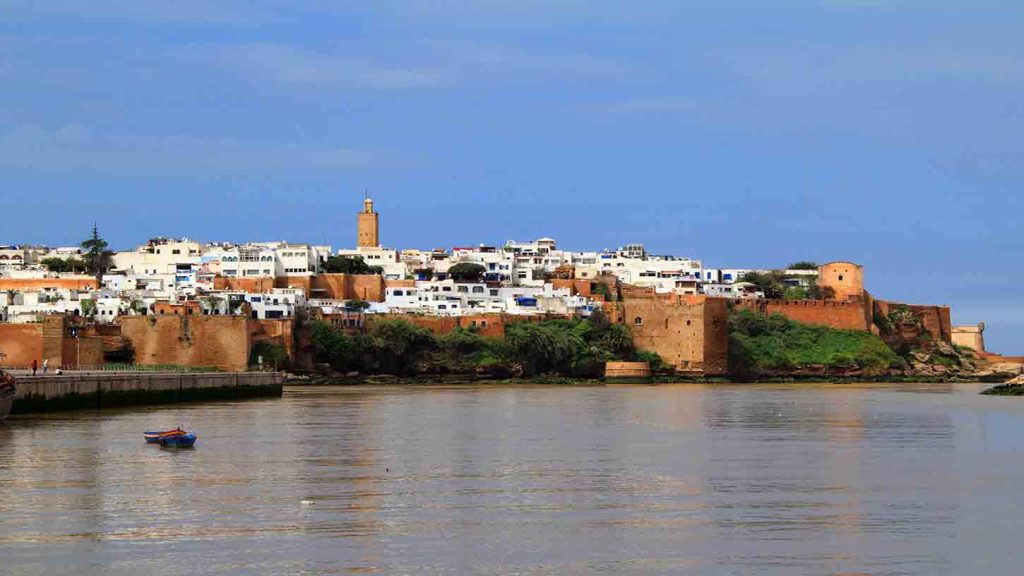 Panoramic view of the historic Udayas Kasbah and its blue-and-white walls overlooking the Atlantic Ocean in Rabat, Morocco